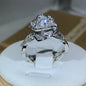 Elegant women's ring in premium 925 sterling silver featuring a three-dimensional design of intertwined roses and white cubic zirconia