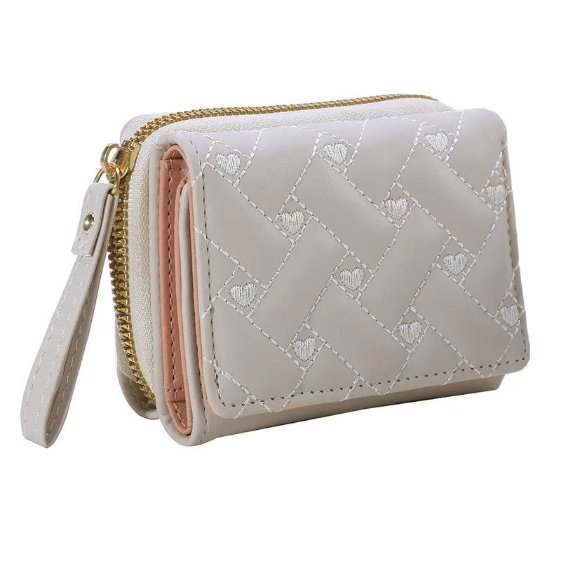Small women's wallet in leather, elegant design, available in various colors.