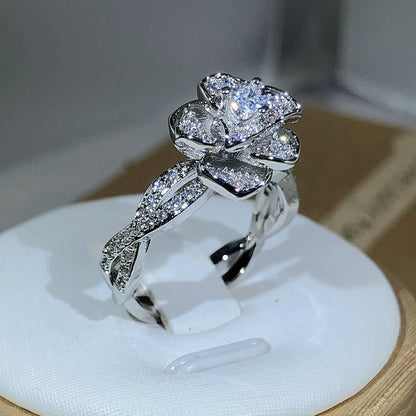 Elegant women's ring in premium 925 sterling silver featuring a three-dimensional design of intertwined roses and white cubic zirconia