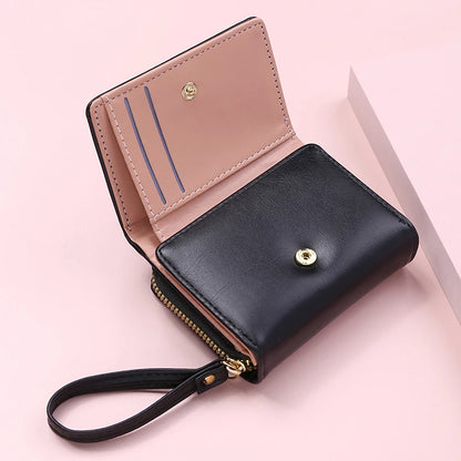 Small women's wallet in leather, elegant design, available in various colors.