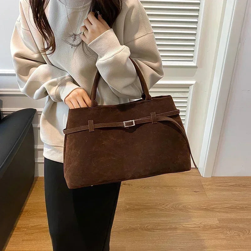 Women's handbag made of synthetic suede with a decorative buckle, large capacity, and snap closure