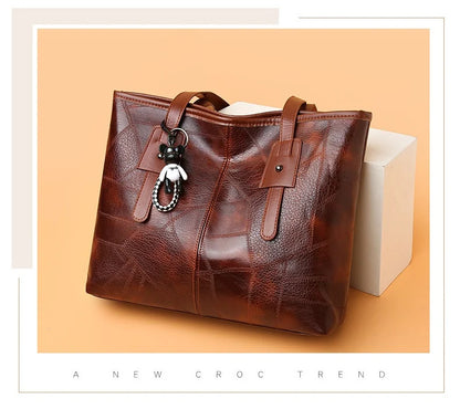 Stylish and elegant women's square tote bag with a horizontal zipper, suitable for carrying by hand or on the shoulder