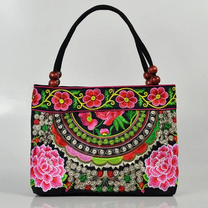Small women's shoulder bag with floral embroidery, top handle, and flap with bead embellishments