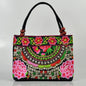 Small women's shoulder bag with floral embroidery, top handle, and flap with bead embellishments