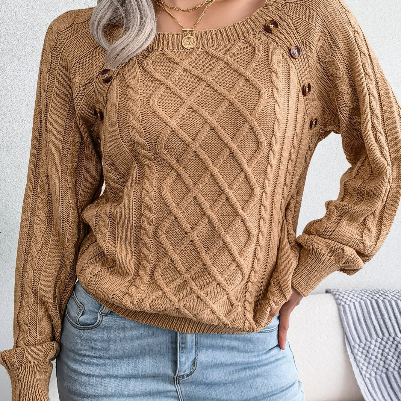 Women's sweater with puff sleeves, textured buttons, and a round neck