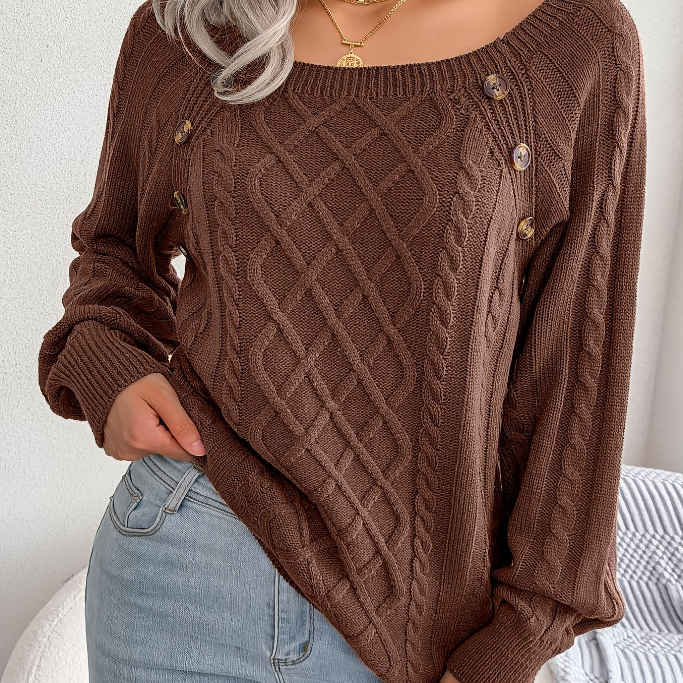 Women's sweater with puff sleeves, textured buttons, and a round neck