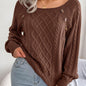 Women's sweater with puff sleeves, textured buttons, and a round neck
