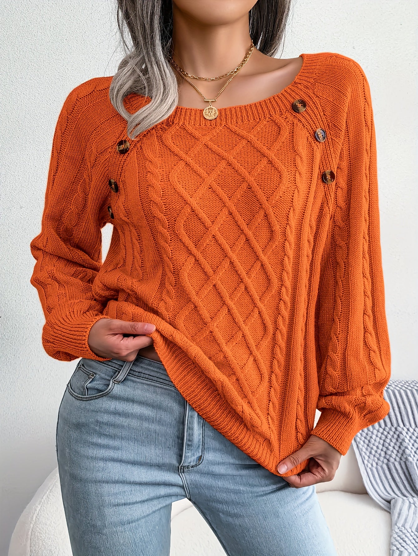 Women's sweater with puff sleeves, textured buttons, and a round neck
