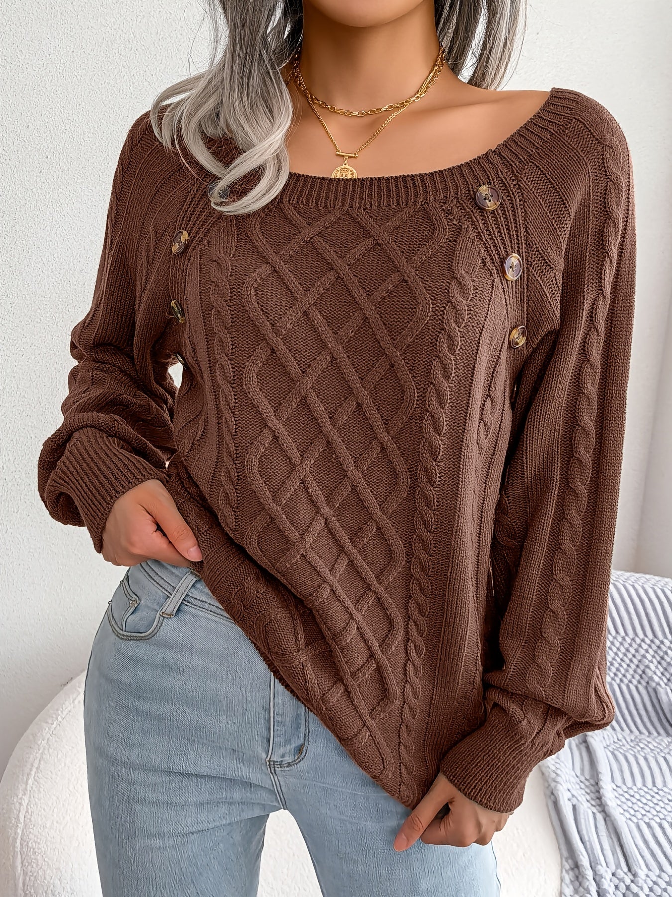 Women's sweater with puff sleeves, textured buttons, and a round neck