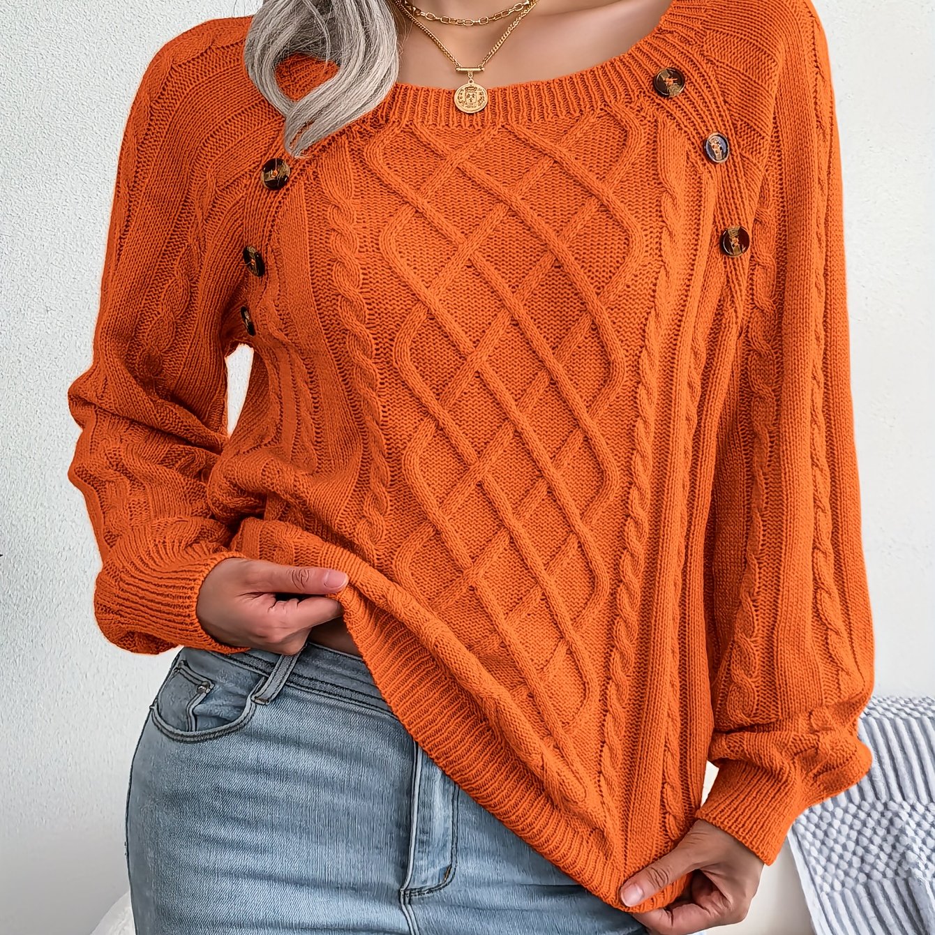 Women's sweater with puff sleeves, textured buttons, and a round neck