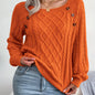 Women's sweater with puff sleeves, textured buttons, and a round neck