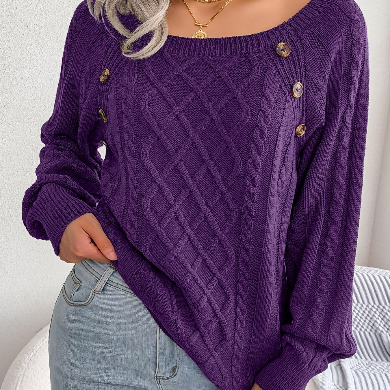 Women's sweater with puff sleeves, textured buttons, and a round neck