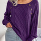 Women's sweater with puff sleeves, textured buttons, and a round neck