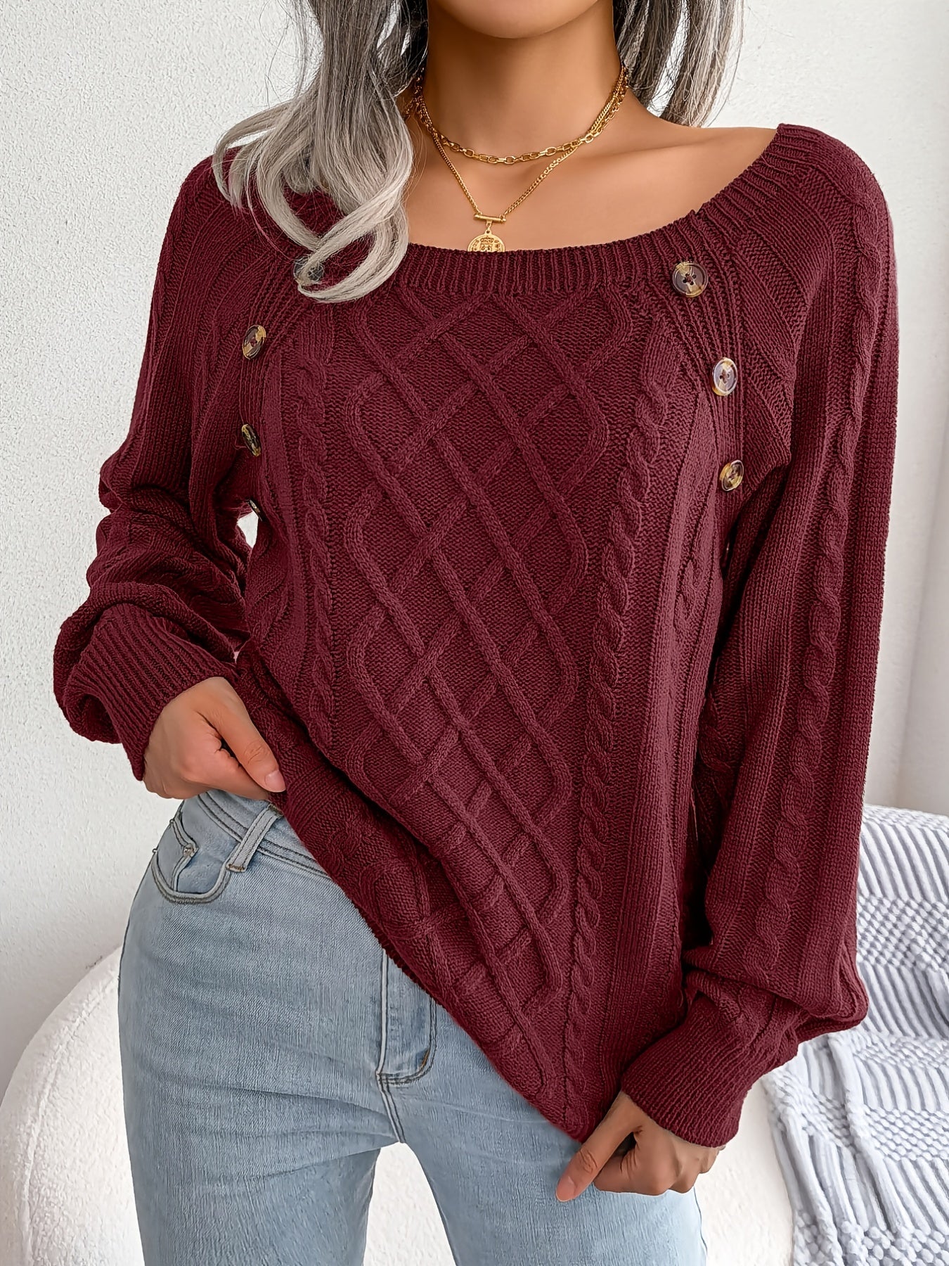 Women's sweater with puff sleeves, textured buttons, and a round neck