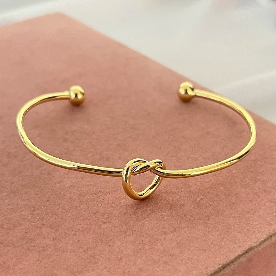Women's rigid stainless steel bracelet with knot detail