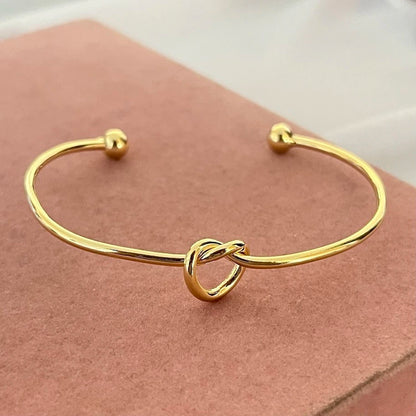 Women's rigid stainless steel bracelet with knot detail